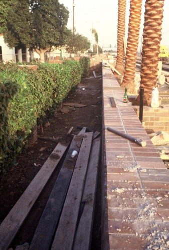 A wall in front of a fence. Now there's a novel idea!